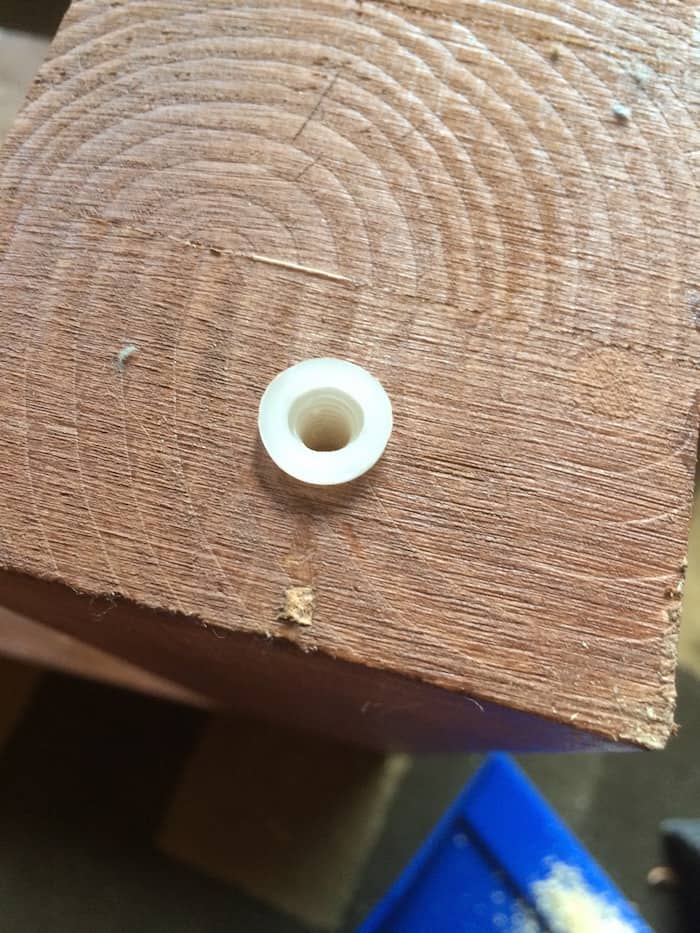 Placing the plastic foot piece into the drilled hole