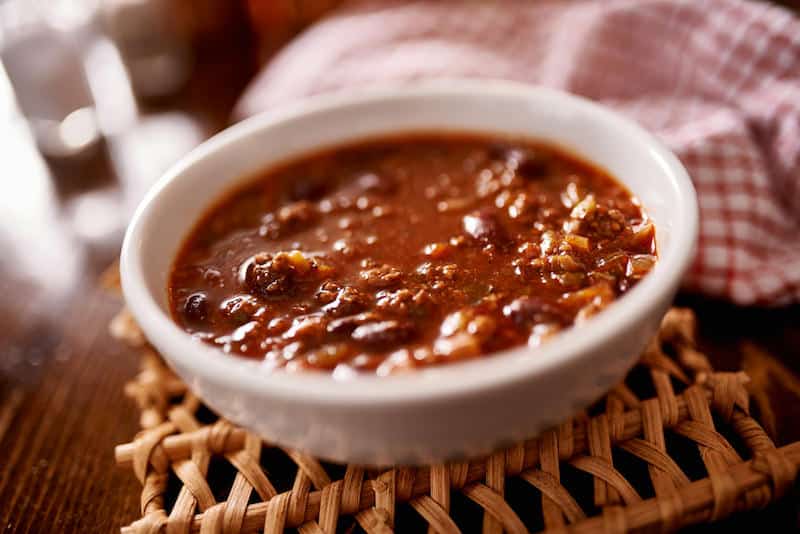 This healthy three bean and ground lean meat Weight Watchers chili recipe is ZERO points on the Freestyle program! It's filling and delicious. Make in the pressure cooker or crockpot!